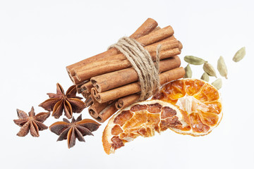 Dried orange, anise stars and cinnamon sticks isolated on white background