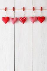 Valentine day background, pillow hearts border on wood, copy space