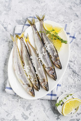 The freshest fish of the northern sea ice fishing smelt with the scent  fresh cucumber on a light...