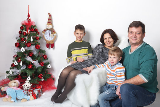 Christmas Family Photo Of 4 People In The Elegant Christmas Tree On A White Background