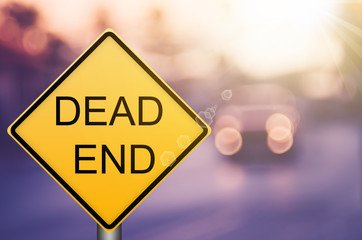 Dead end warning sign on blur traffic road with colorful bokeh light abstract background. - obrazy, fototapety, plakaty