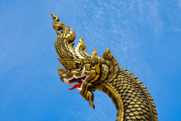 Naga statue head with blue sky background.