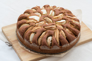 Vegetarian apple cake on a wooden board