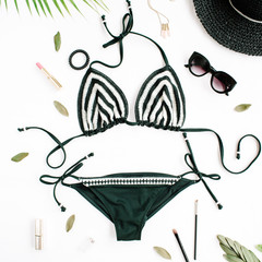 female summer bikini swimsuit accessories collage on white with hat, green branches, necklace and sunglasses. flat lay, top view