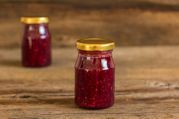 Homemade jam with raspberry on the wooden table