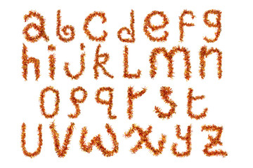 Festive alphabet made of  red and yellow tinsel on a white background. Isolated