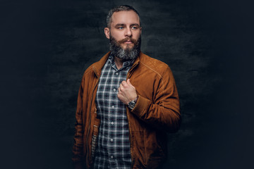 Bearded middle age male dressed brown leather jacket.