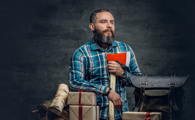 Middle age male holds an axe and gift boxes.