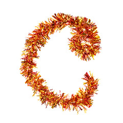 Festive alphabet made of red and yellow tinsel. Letter C on white background. Isolated