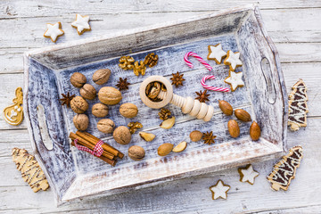 Christmas cookies and nuts with winter spices on a wooden background.  


