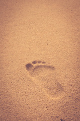 Copy space of footprint on sand beach texture background.