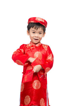 Little Vietnamese boy holding red envelops for Tet. The word mea