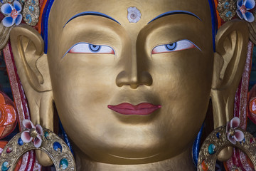 close up of maitreya buddha statue in thiksey monastery