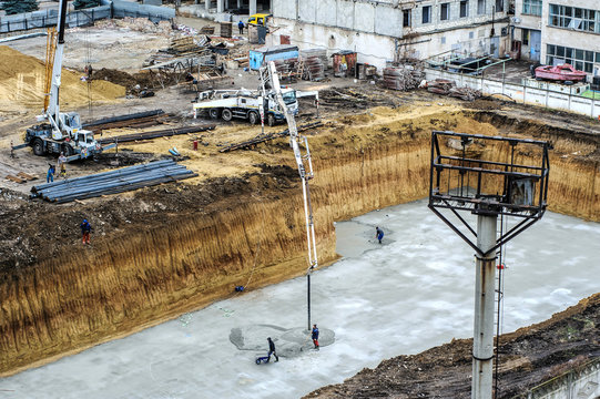 builders build a foundation from cement  to a new building