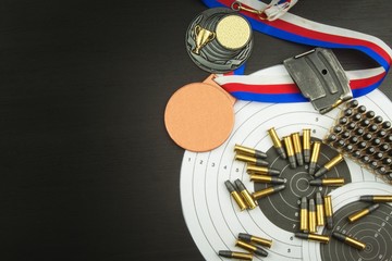 Concept of shooting competitions. Sport shooting. Biathlon background diploma. Tools and targets on wooden background. Caliber ,22
