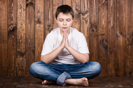 Boy in a suit in lotus position
