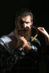 Female hands shave bearded man
