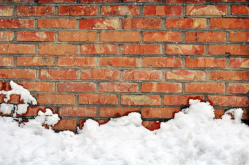 White snow on red brick wall