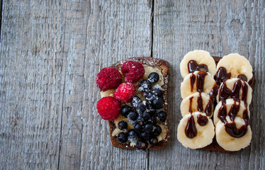 Top view of open sandwiches. Bread with nuts, bananas, berries, sausage, cheese, vegetables. Perfect for the detox diet or just a healthy meal.  Love for a healthy raw food concept.