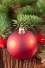 Red Christmas bauble on wooden background