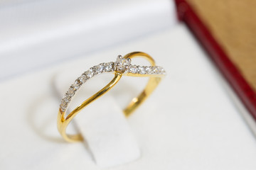 Diamond ring, gold body on white base