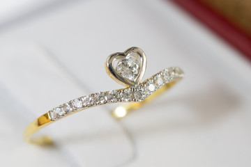 Diamond ring, gold body on white base