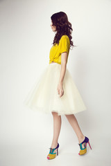 woman in yellow shirt and white skirt