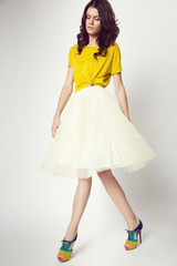 woman in yellow shirt and white skirt