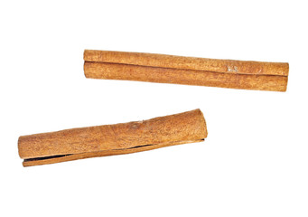 Two cinnamon sticks on white background