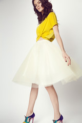 woman in yellow shirt and white skirt