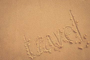 Copy space of travel words hand write on sand beach texture background.