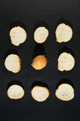 sliced bread slices on a black background, top view