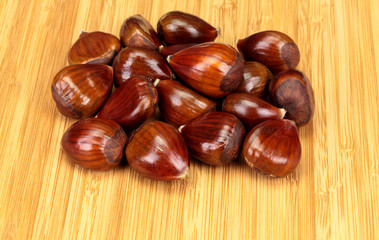 Group of Chestnuts (Castanea), on a wooden board