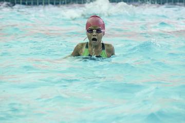 Little girl swimming in the pool