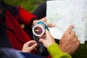 Father holds the card, a child holding a compass.