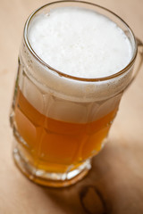 Mug of wheat beer on wood