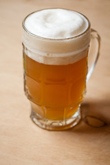 Mug of wheat beer on wood
