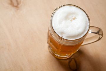 Mug of wheat beer on wood