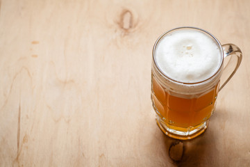 Mug of wheat beer on wood