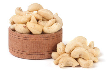 cashew nuts in a wooden bowl isolated on white background