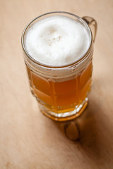 Mug of wheat beer on wood