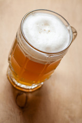 Mug of wheat beer on wood