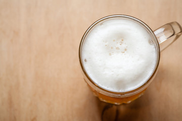 Mug of wheat beer on wood
