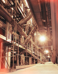 Equipment, cables and piping as found inside of a modern industr