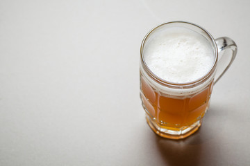 Mug of beer on gray