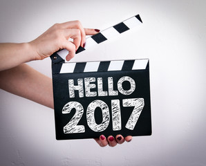 Hello 2017. Female hands holding movie clapper. 