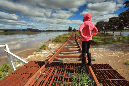 Floodwaters Run Under Buckled Train Tracks