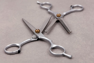 Stylish Professional Barber Scissors, Hair Cutting and Thinning Scissors on light grey background. Hairdresser salon concept, Hairdressing Set. Haircut accessories.