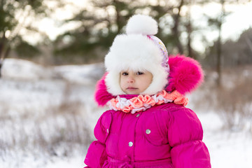 Kids, little girls, sisters sledding in the winter forest. Winter fun for children.