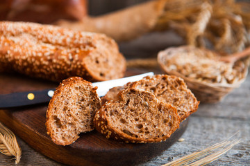 Fototapeta na wymiar Sliced rye bread on a Board. On a wooden rustic table.